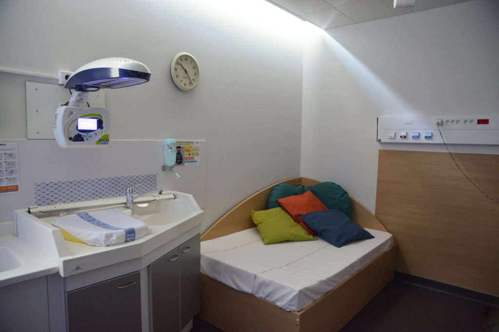 Photo d'une banquette avec des coussins à côté du baby-bloc dans la salle nature